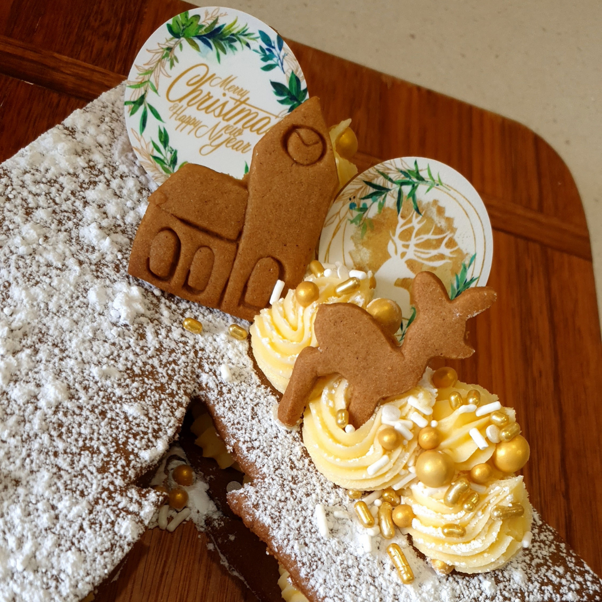 Close up of cookie cake toppers little gingerbread deer cookies and town hall cookies made with DoughCuts cookie cutters