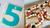Image of number 5 cookie cake template next to a number 50 mille feuille made using the DoughCuts number stencils