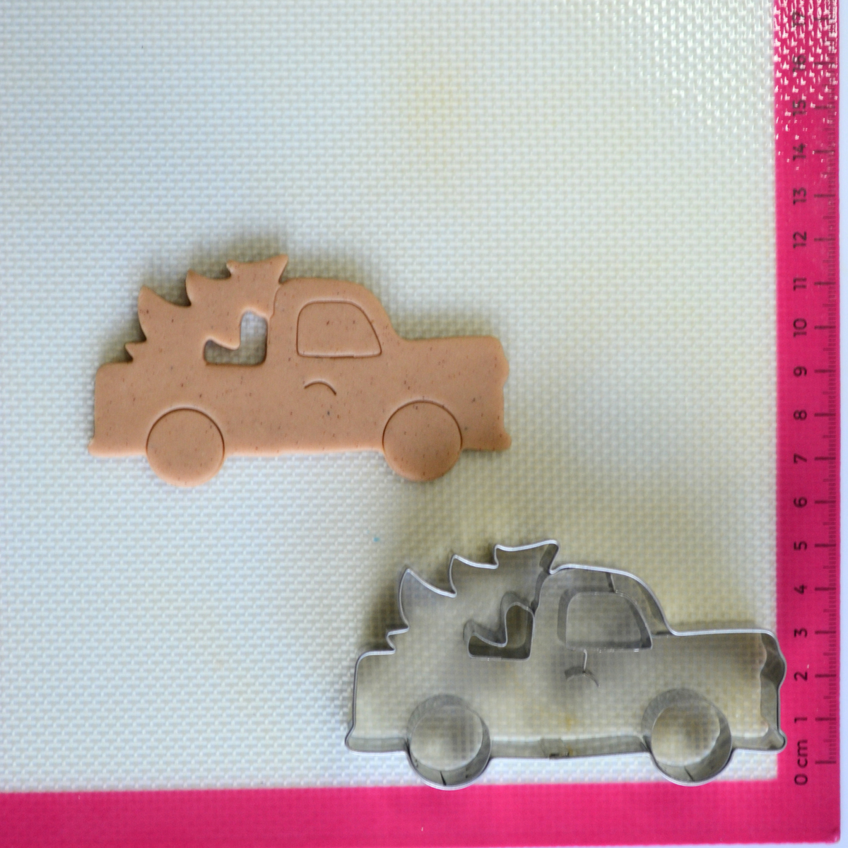 Cookie cutout of Christmas tree on back of truck with cookie cutter with internal details