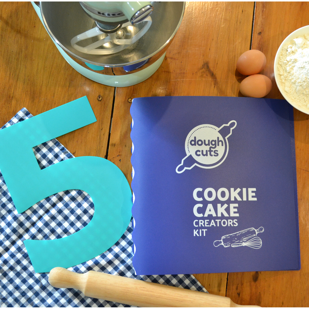 Cookie Cake Creators Kit Folder with the number 5 reusable baking template included sitting next to the folder.