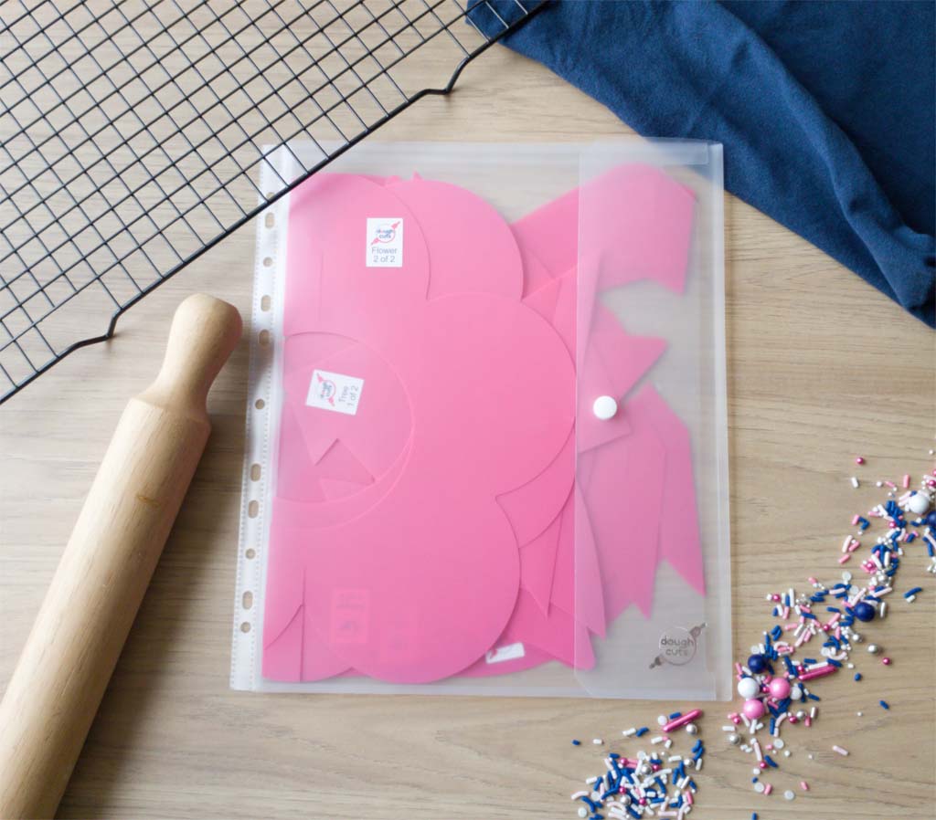 Image of everyday shapes set of cookie templates in the plastic binder sleeve they come packaged in.